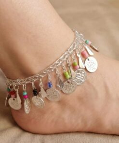 Silver oriental anklet with coin charms and colorful beads worn on foot خلخال فضي شرقي مزين بعملات معدنية وخرز ملون على القدم Bracelet de cheville oriental argenté avec pièces métalliques et perles colorées porté au pied