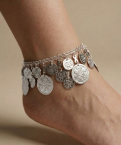 Silver oriental anklet with coin charms and colorful beads worn on foot خلخال فضي شرقي مزين بعملات معدنية وخرز ملون على القدم Bracelet de cheville oriental argenté avec pièces métalliques et perles colorées porté au pied